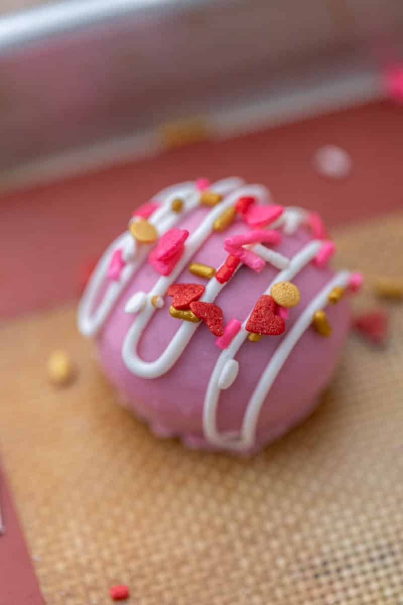 Pink Valentine's day Oreo truffle on baking sheet
