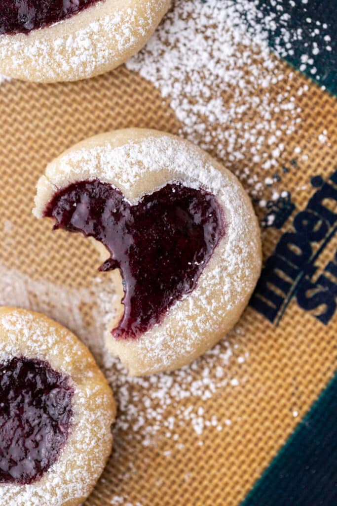 Valentine's day thumbprint cookies with a bite taken out of it