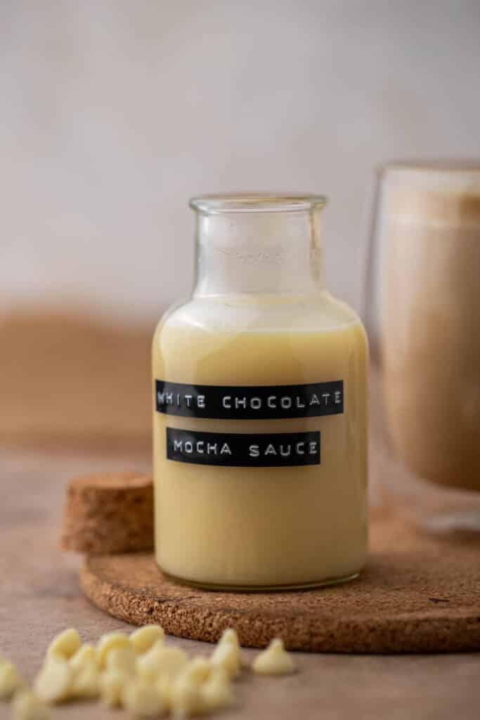 Homemade white chocolate mocha sauce in a small glass bottle