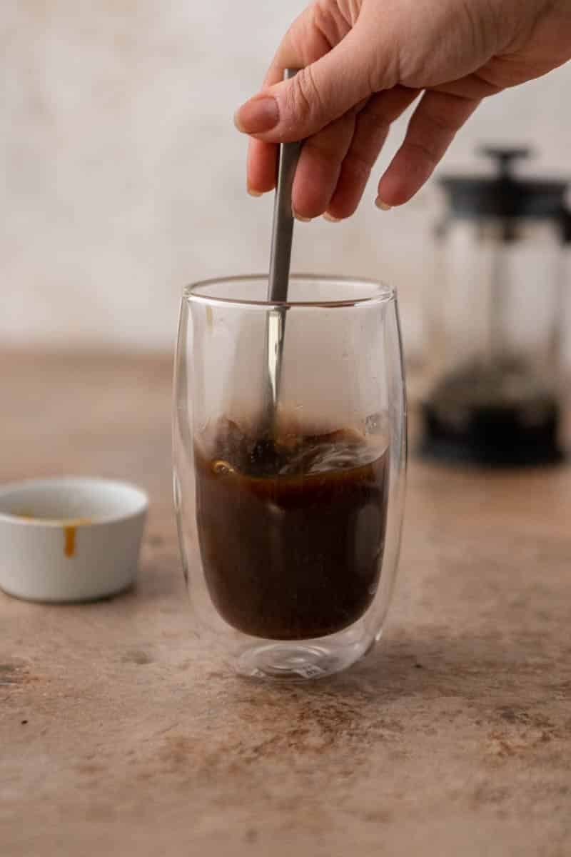 Hand stirring coffee