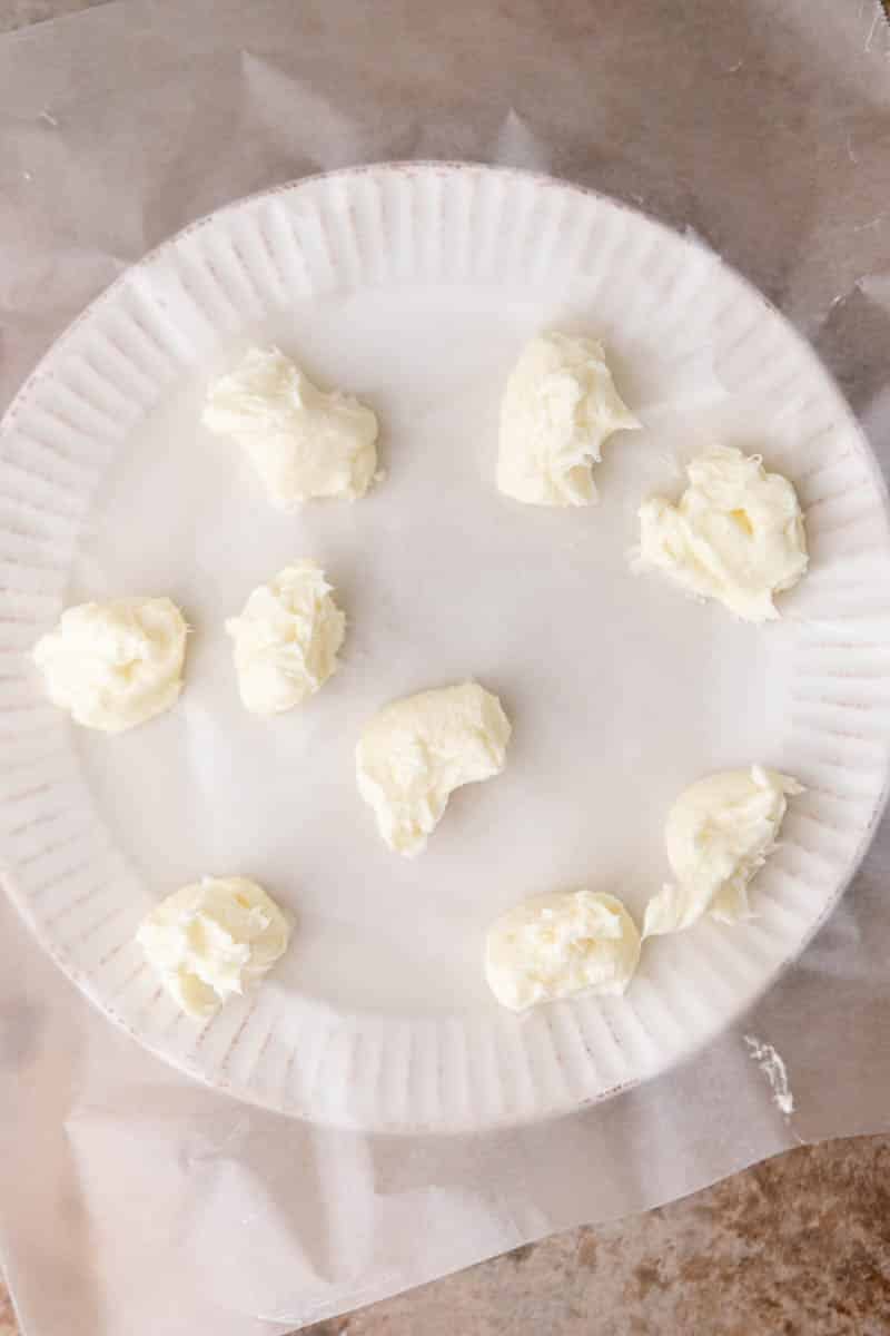 Cream cheese dollops on a plate