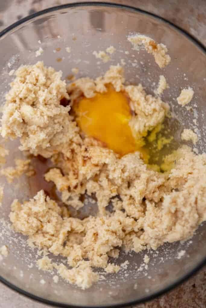 Egg being mixed into cookie dough