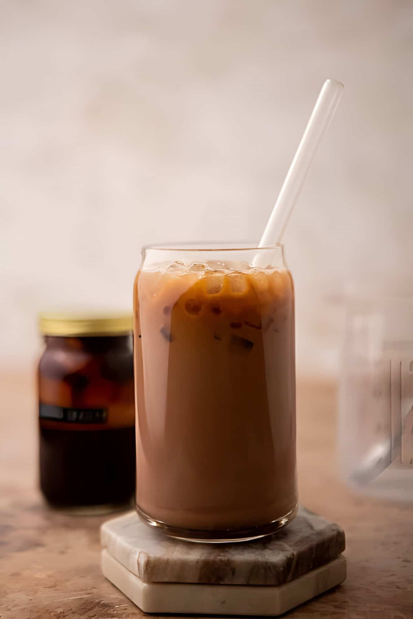 Tall glass of iced mocha latte with espresso layered over chocolate milk and ice.