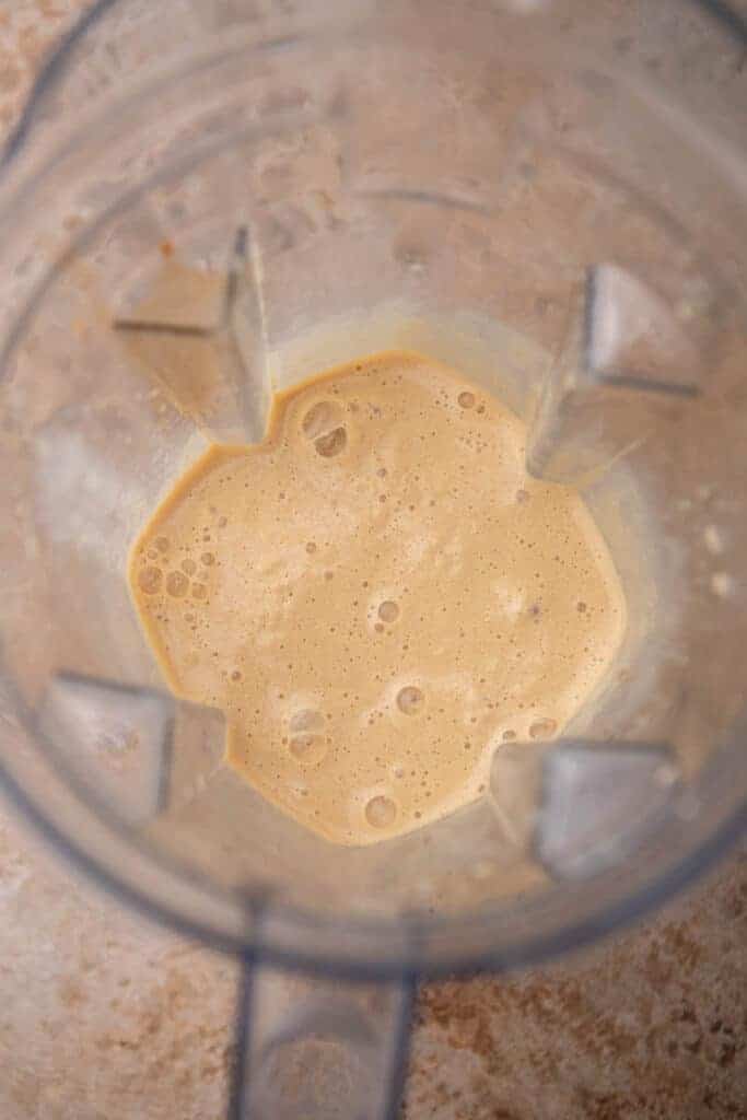 Smooth blended caramel frappe mixture in a blender, ready to pour