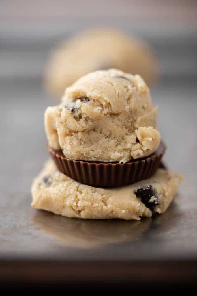 Raw peanut butter cup stuffed cookie dough ball before sealing and baking