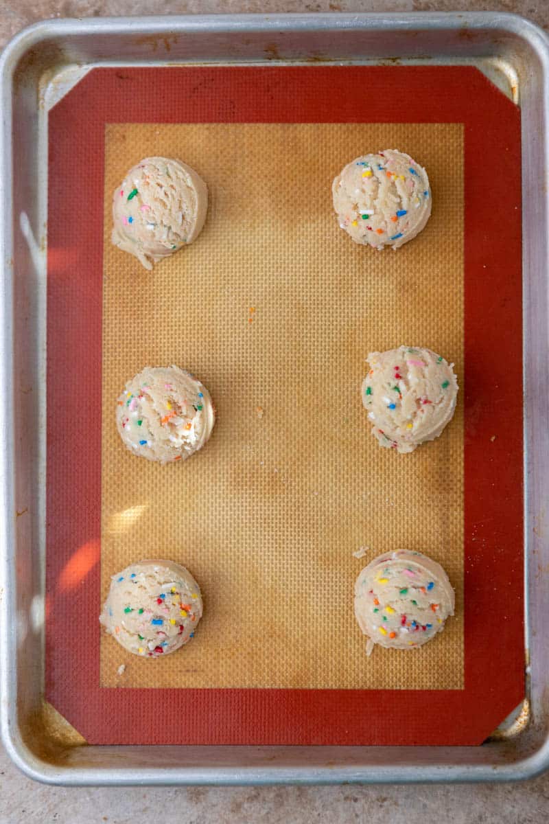 Sprinkle cookie dough balls on baking sheet
