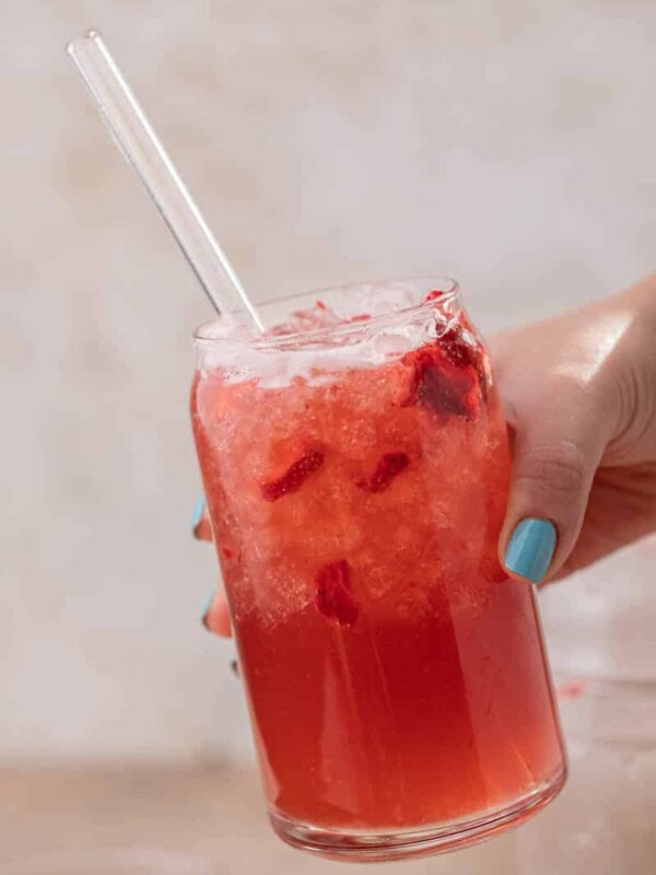 Hand holding Starbucks strawberry acai refresher