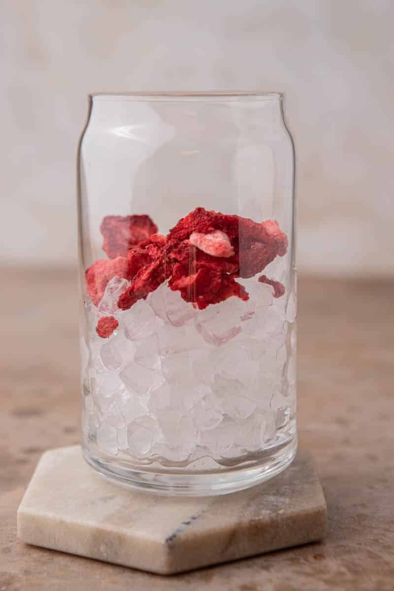 Glass full of ice and freeze dried strawberries