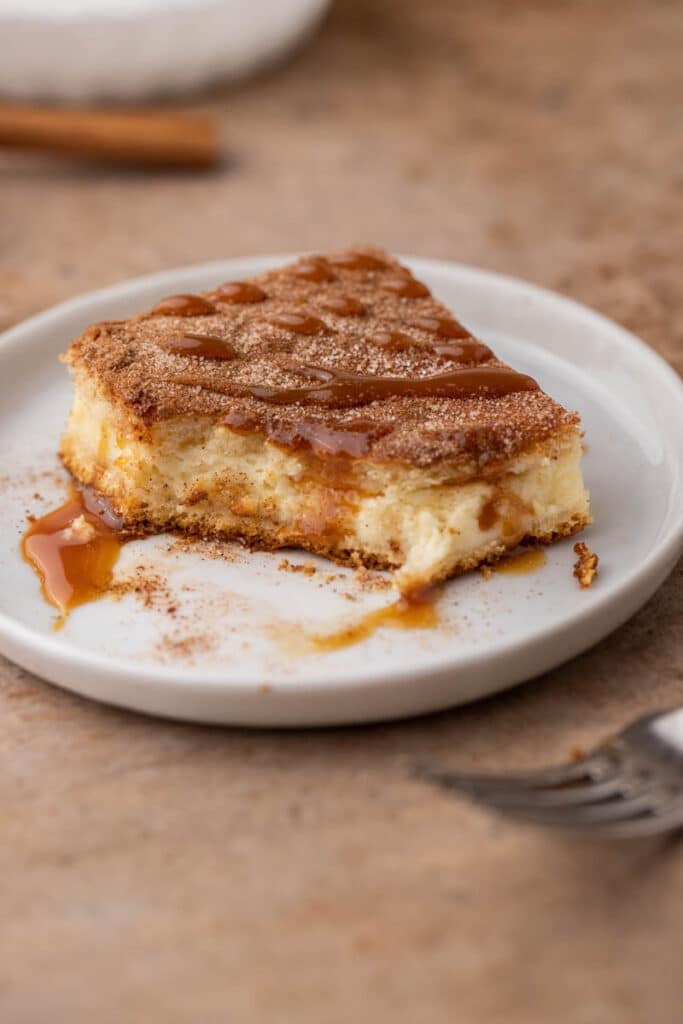 Churro cheesecake bars with a bite taken out of it