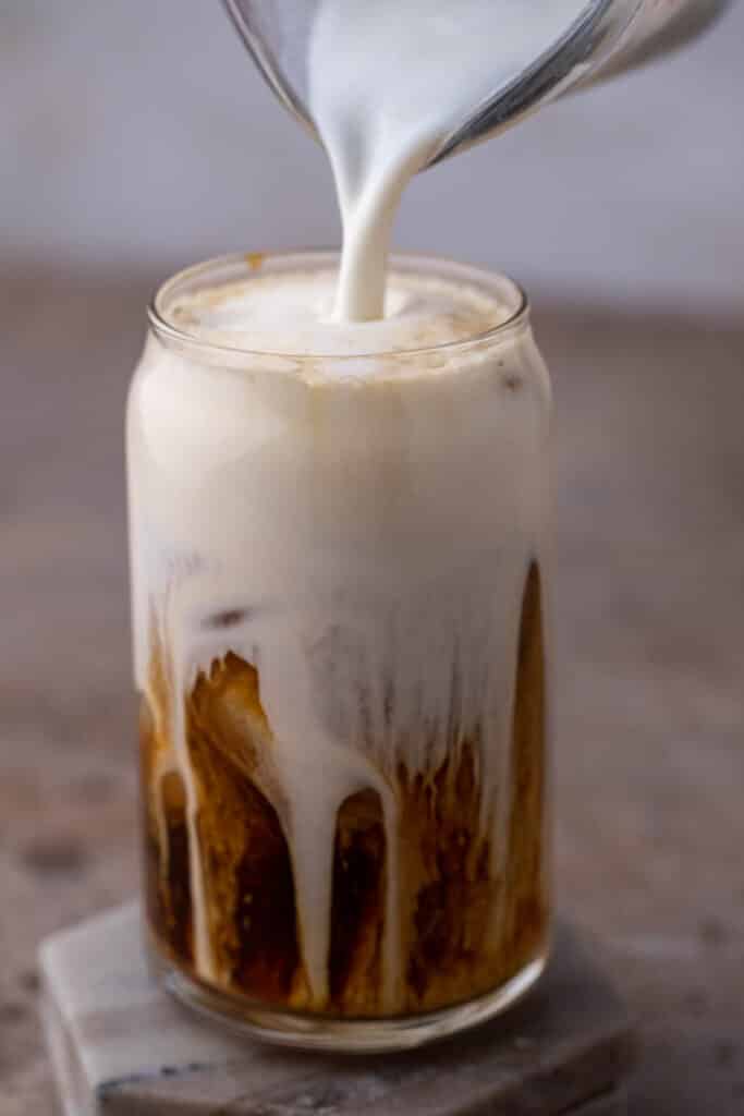 Pouring the foam on top of cold brew