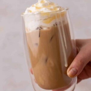 Hand holding iced Starbucks white mocha