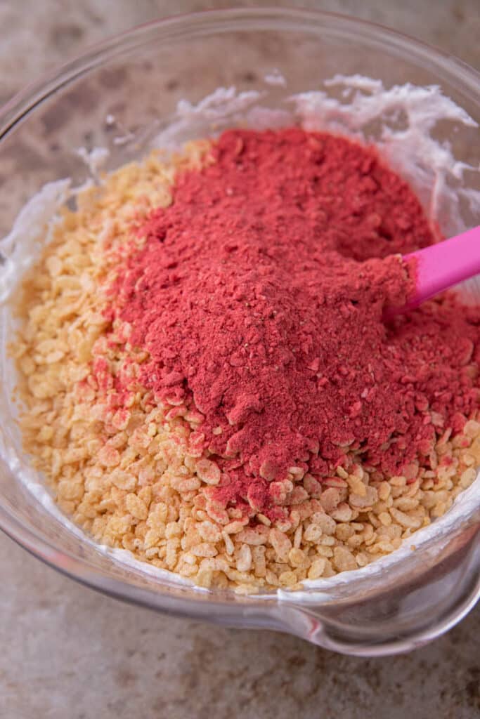 Rice crispy cereal and freeze dried strawberry powder in a bowl