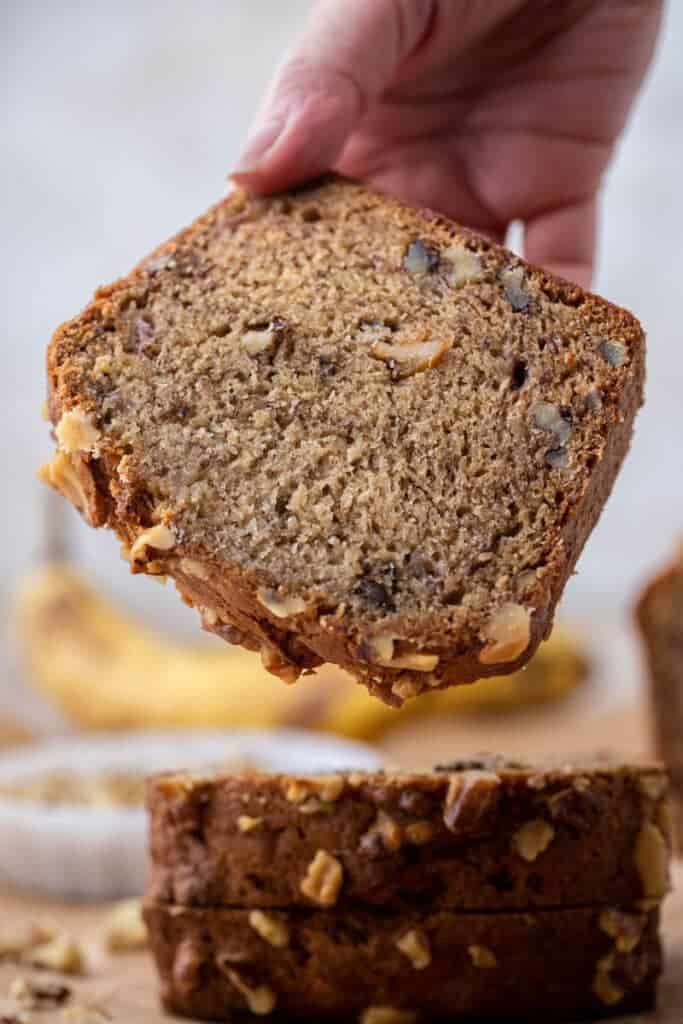Moist Starbucks copycat banana bread slice with walnuts showing dense bakery-style crumb