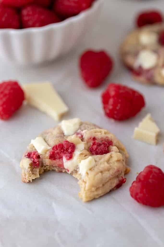 White chocolate raspberry cookie with a bite taken out of it