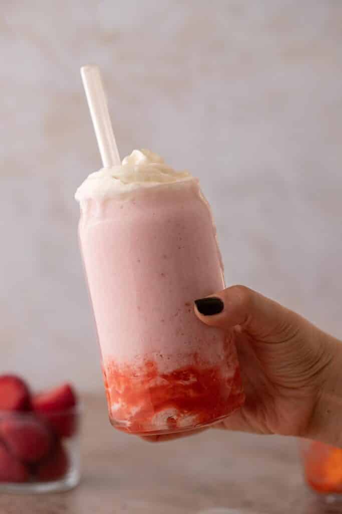 Hand holding copycat Starbucks strawberry creme frappuccino