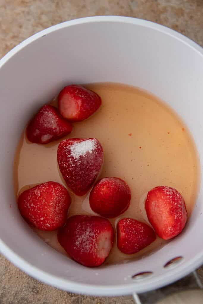 Strawberries and grape juice in a pan