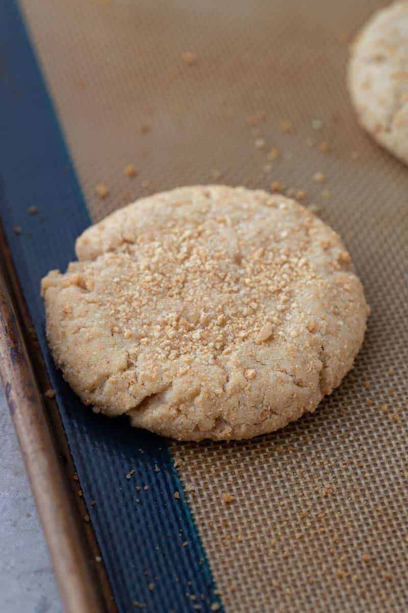 A baked graham cracker cookie on a silicone baking mat.