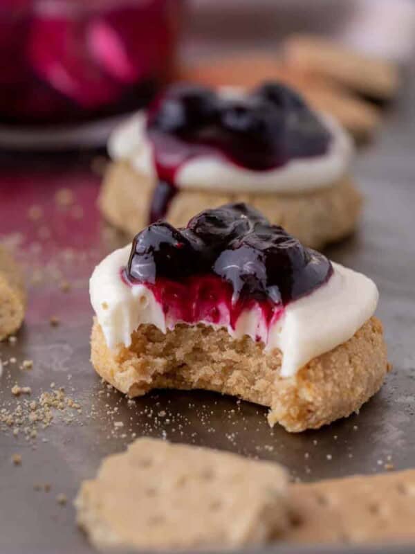 ini Crumbl blueberry cheesecake cookies with a bite taken out of them