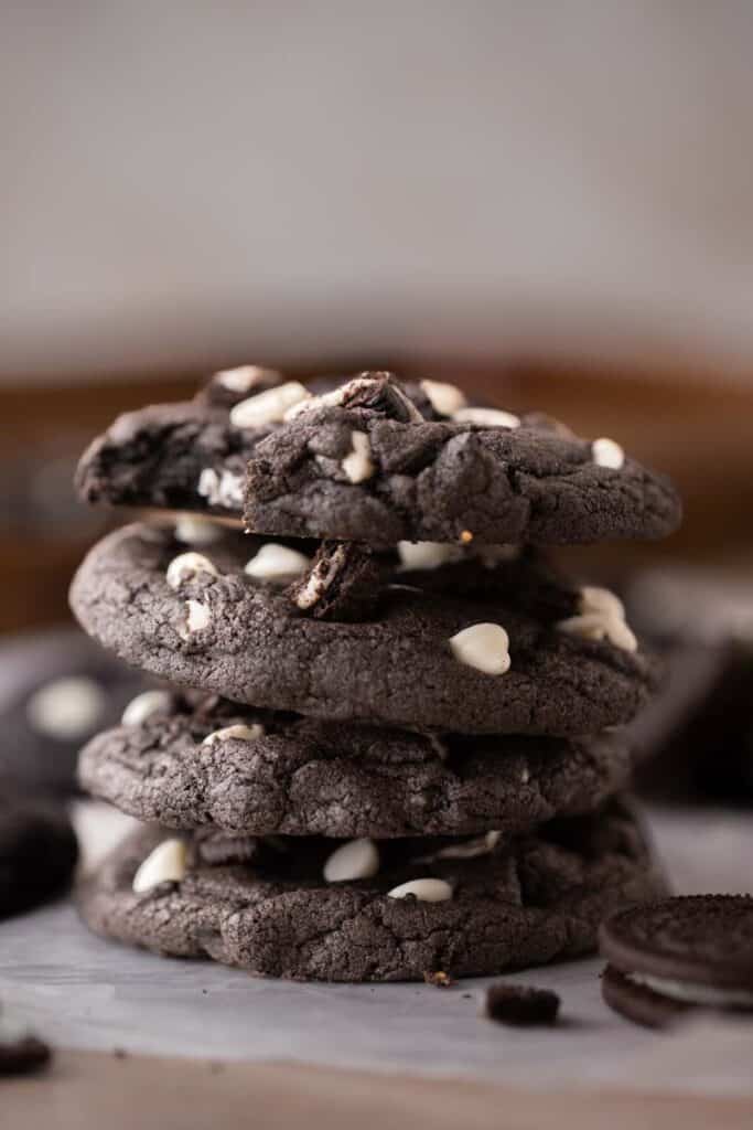 Stack of Crumbl chocolate cookies and cream cookies