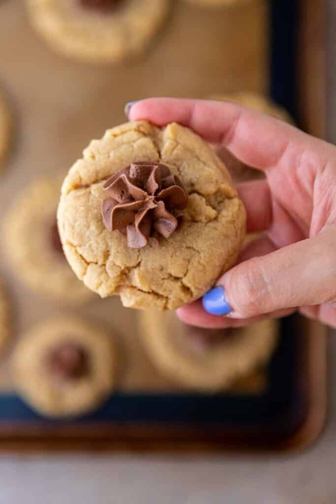 
Hand holding mini peanut butter blossom cookies