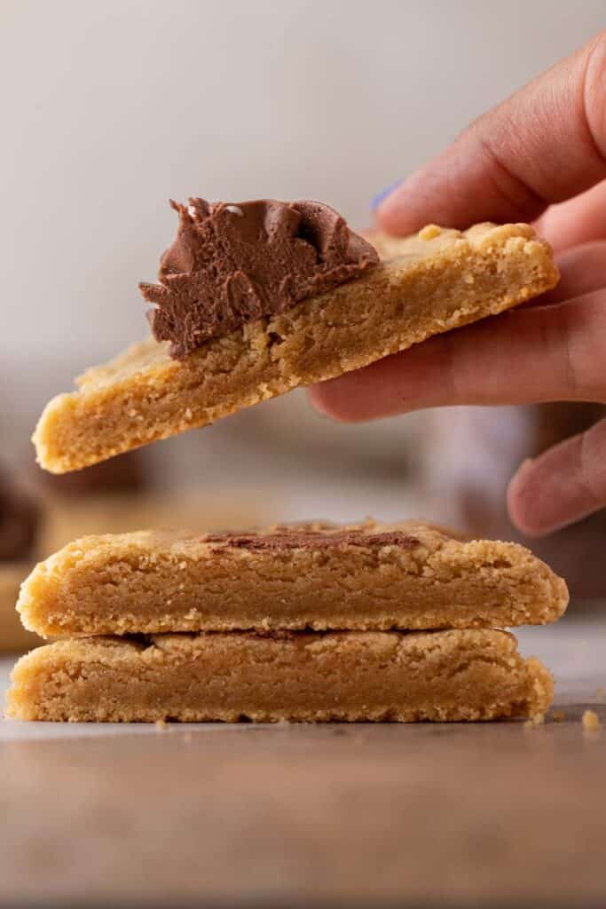 Crumbl peanut butter blossom cookies sliced in half