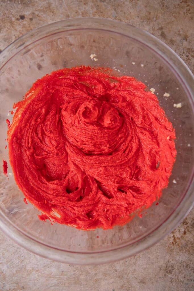 Creamed butter with red food coloring in a bowl