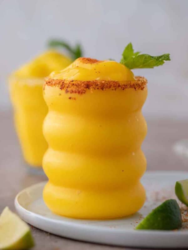 Frozen mango margaritas in wiggly glass