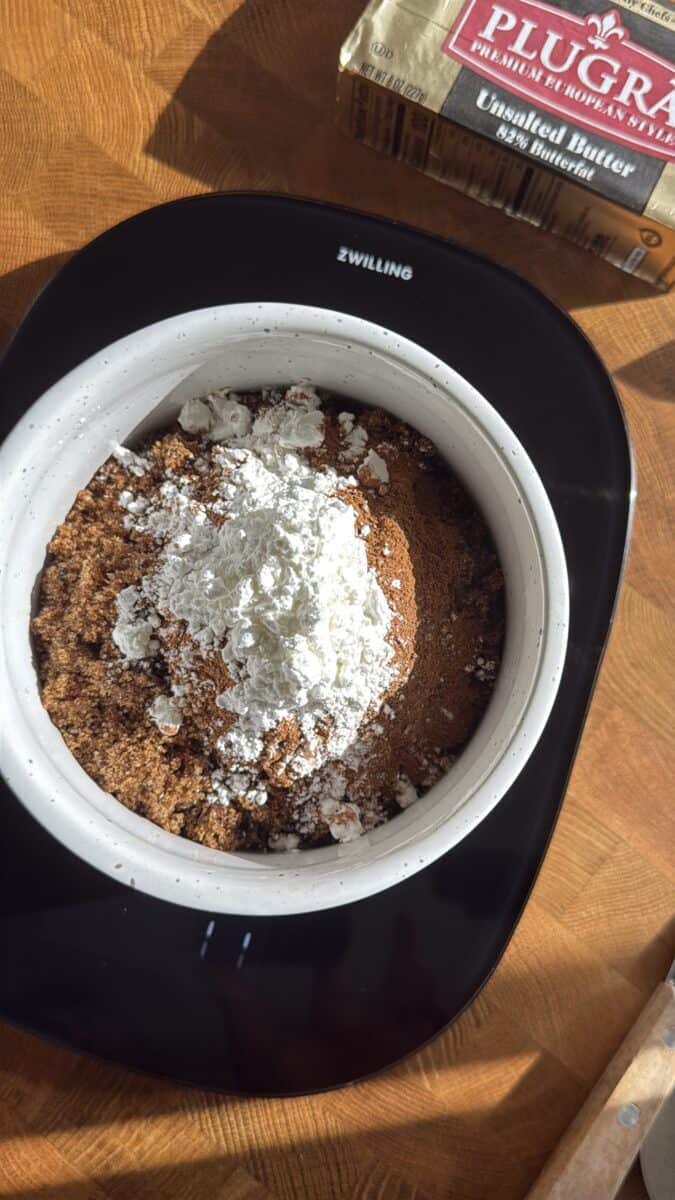 Brown sugar, cinnamon, and flour mixed together in a bowl for cinnamon roll filling