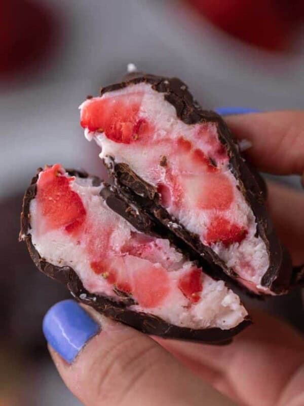Hand holding strawberry yogurt clusters