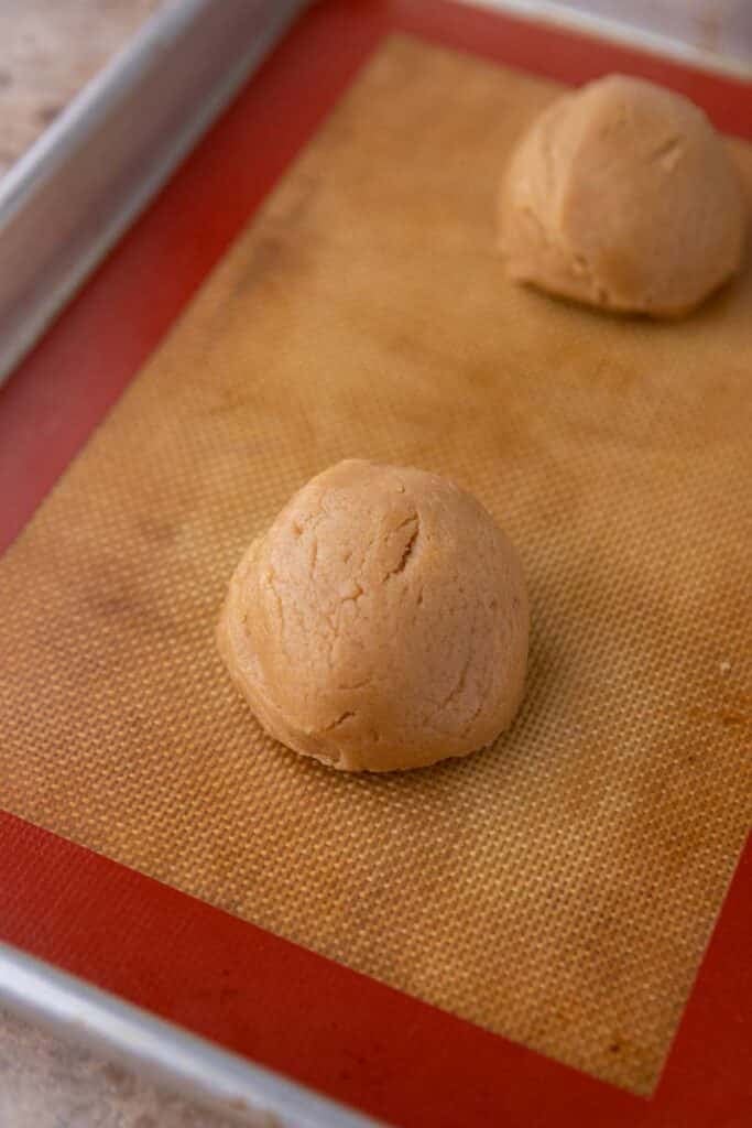 Cookie dough ball on baking sheet
