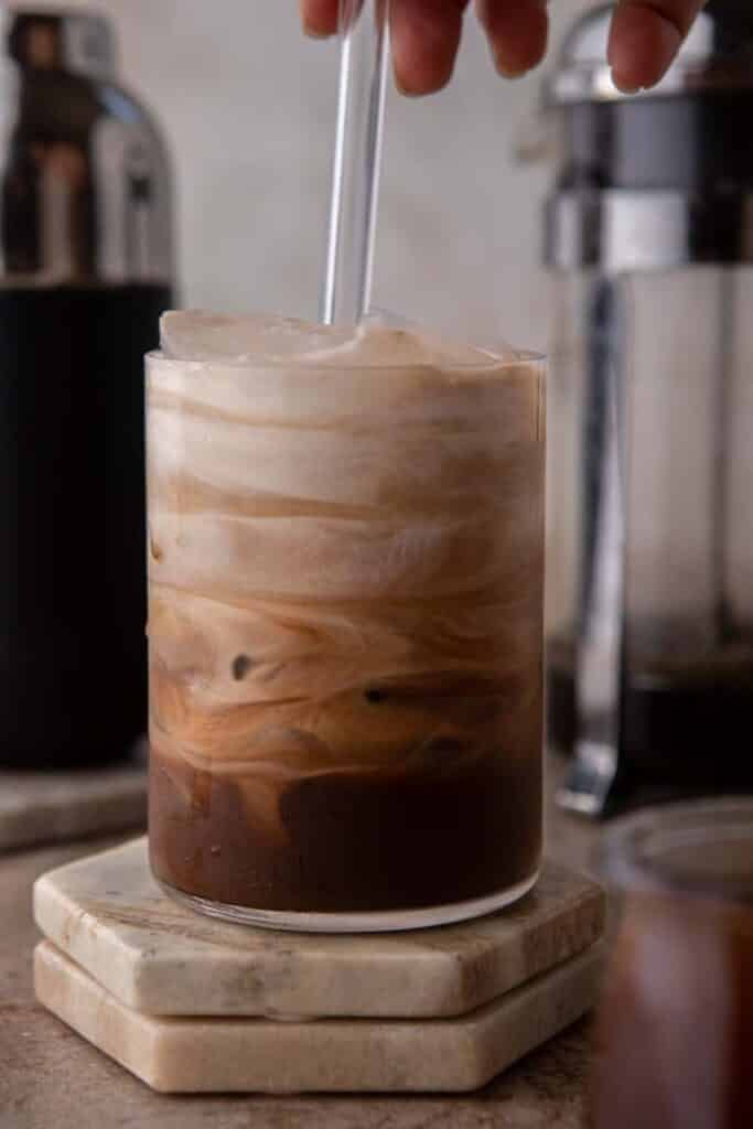 Hand stirring iced mocha coffee