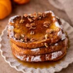 Pumpkin french toast with pecans and maple syrup on top