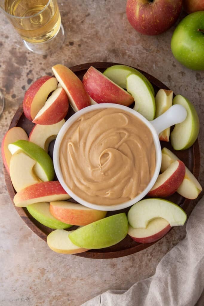 Caramel sauce dip for apple on a serving board
