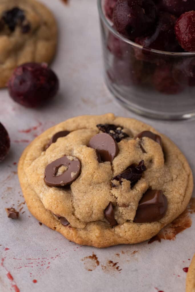 close up of a brown butter cherry chocolate chip cookie