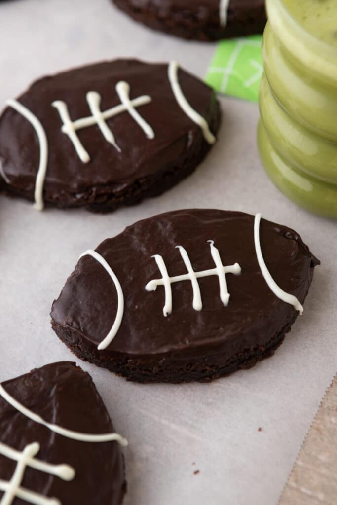 Football shaped brownies next to cup