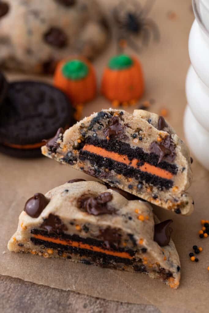 Halloween Oreo stuffed chocolate chip cookies split in half and stacked in a staggered style