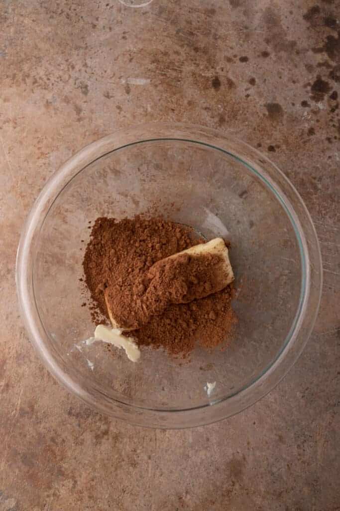 the first group of ingredients in the bowl for the brownie frosting recipe