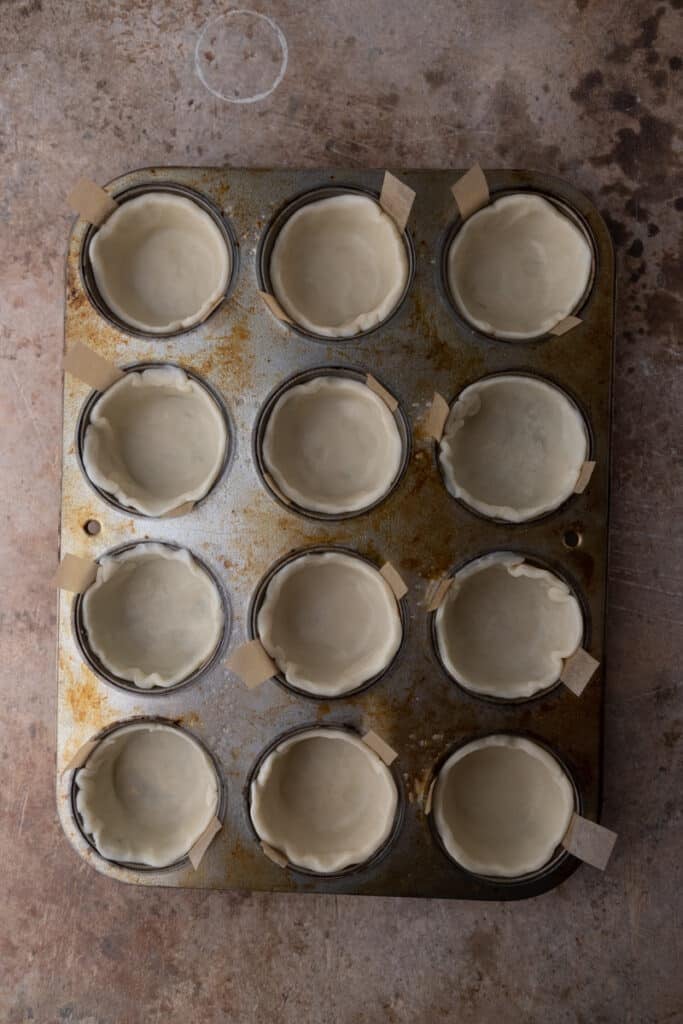 empty pie shells in a muffin tin