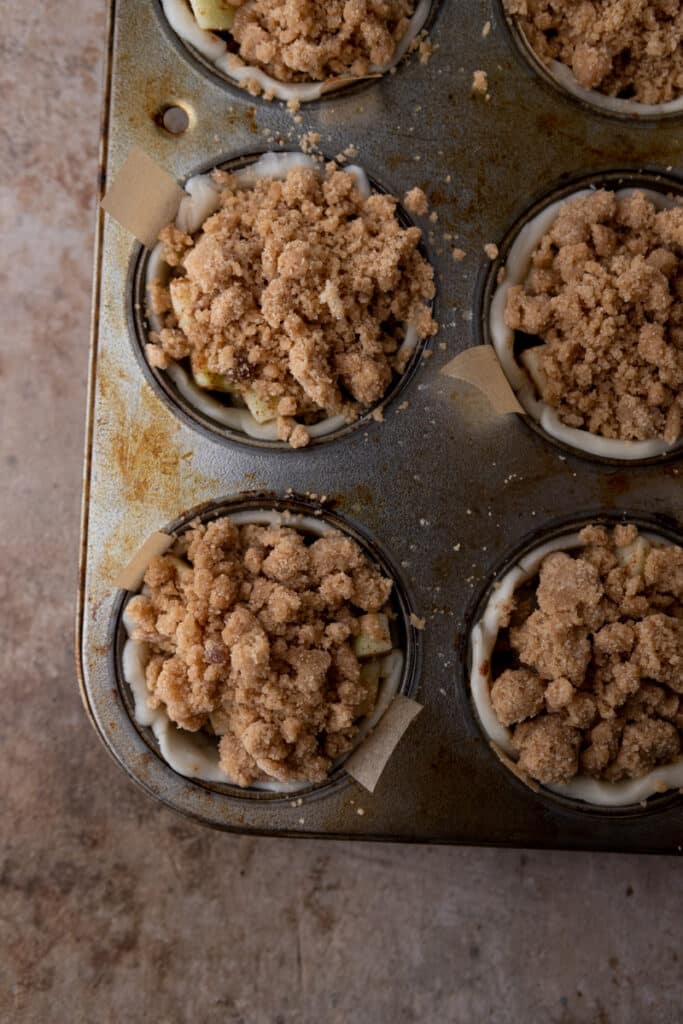 baked mini apple pies in a muffin tin