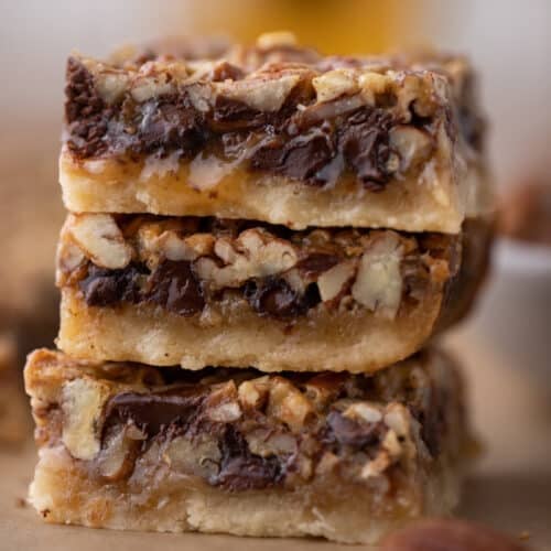3 chocolate pecan pie bars stacked on top of each other