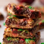 a stack of christmas magic cookie bars on top of each other
