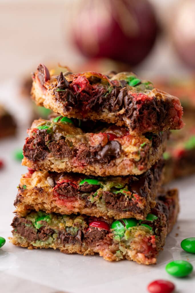 a stack of christmas magic cookie bars on top of each other