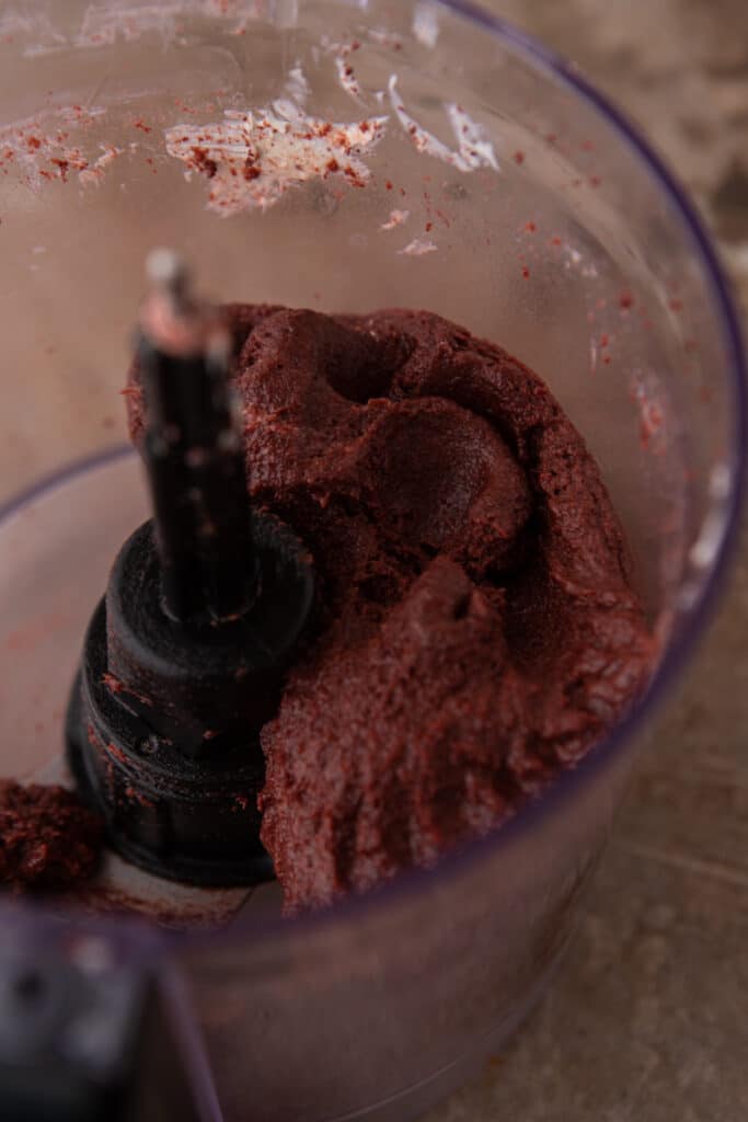 oreo and cream cheese being blended together in a food processor