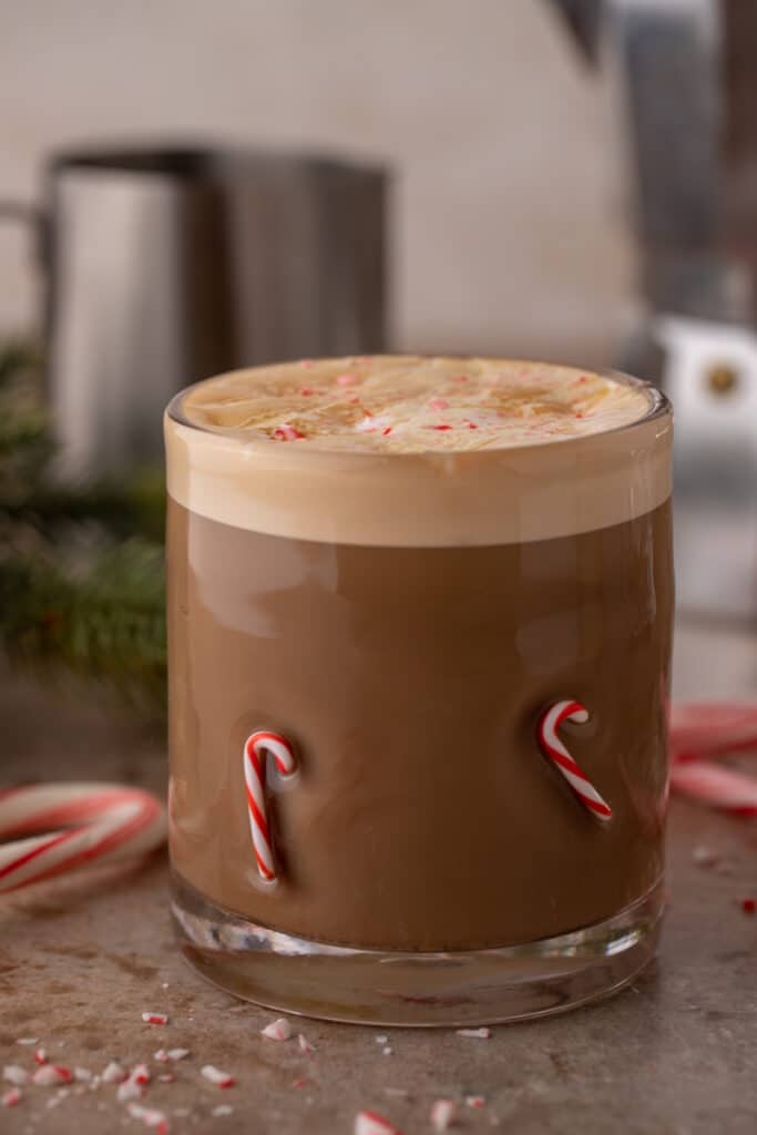 peppermint white chocolate mocha in a glass with frothed milk on top