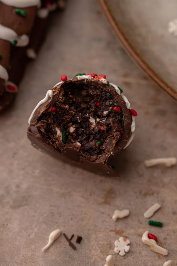 close up of a single Little Debbie Chocolate Christmas tree cakes truffles with a bite taken out