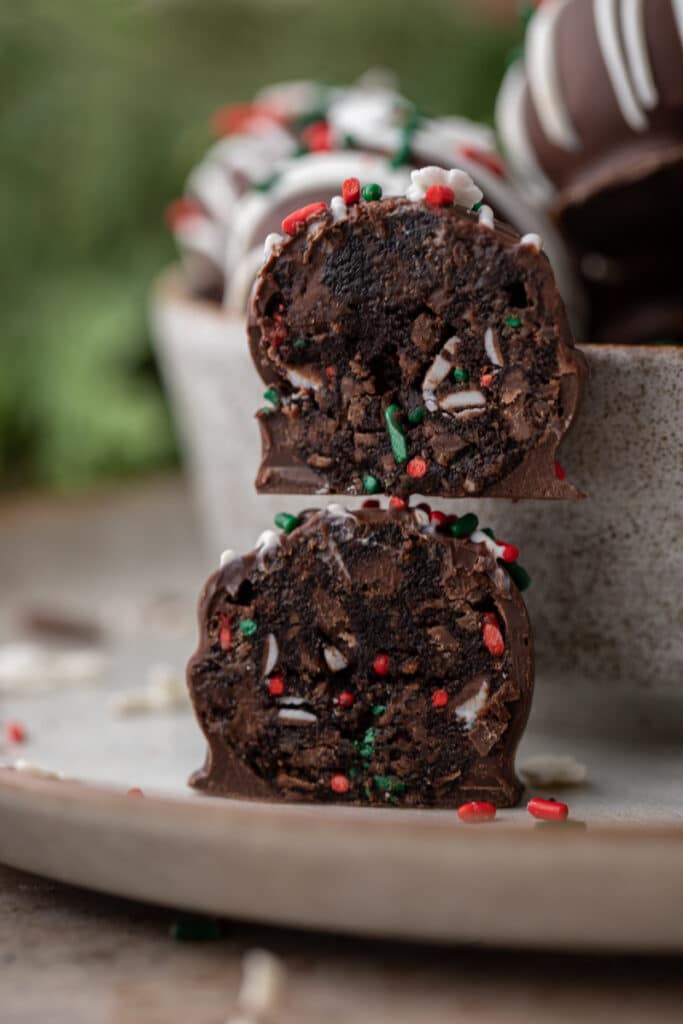 two halves of Little Debbie Chocolate Christmas tree cakes truffles stacked on top of each other