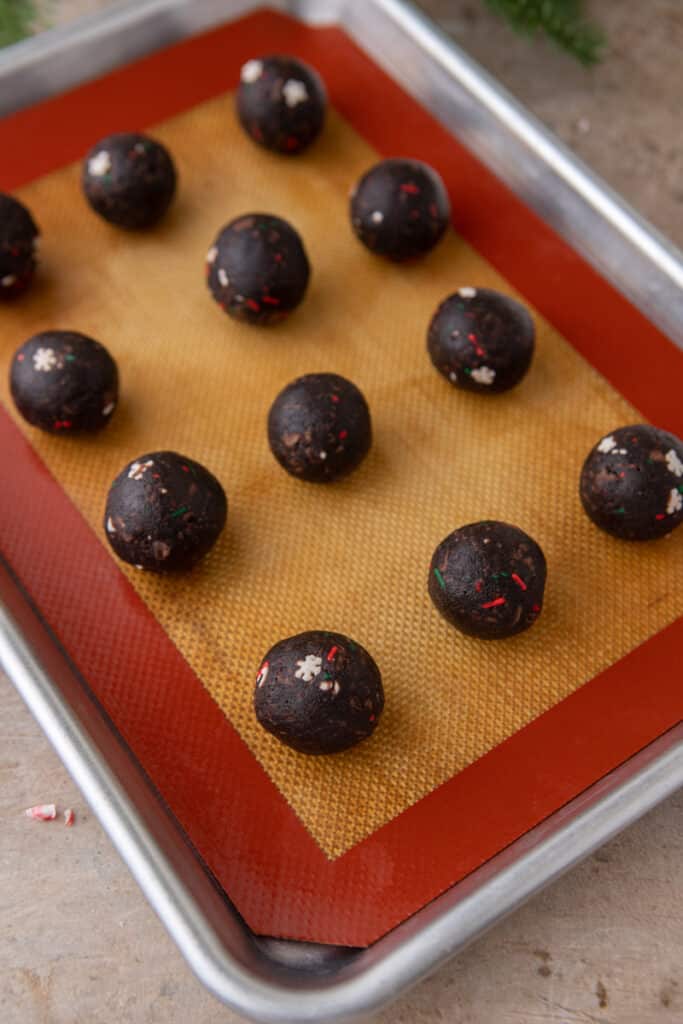 cake balls lined up on a baking sheet