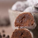 Two chocolate cookies stacked to show their soft