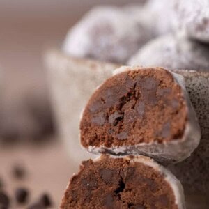 Two chocolate cookies stacked to show their soft