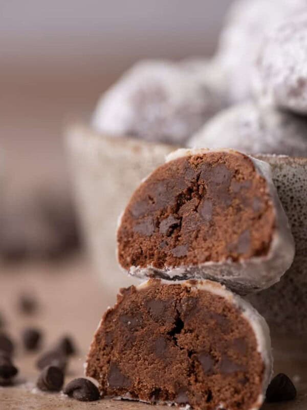 Two chocolate cookies stacked to show their soft